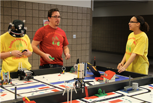 Advisor helps yellow team revise robot design Advisor helps yellow team revise robot design